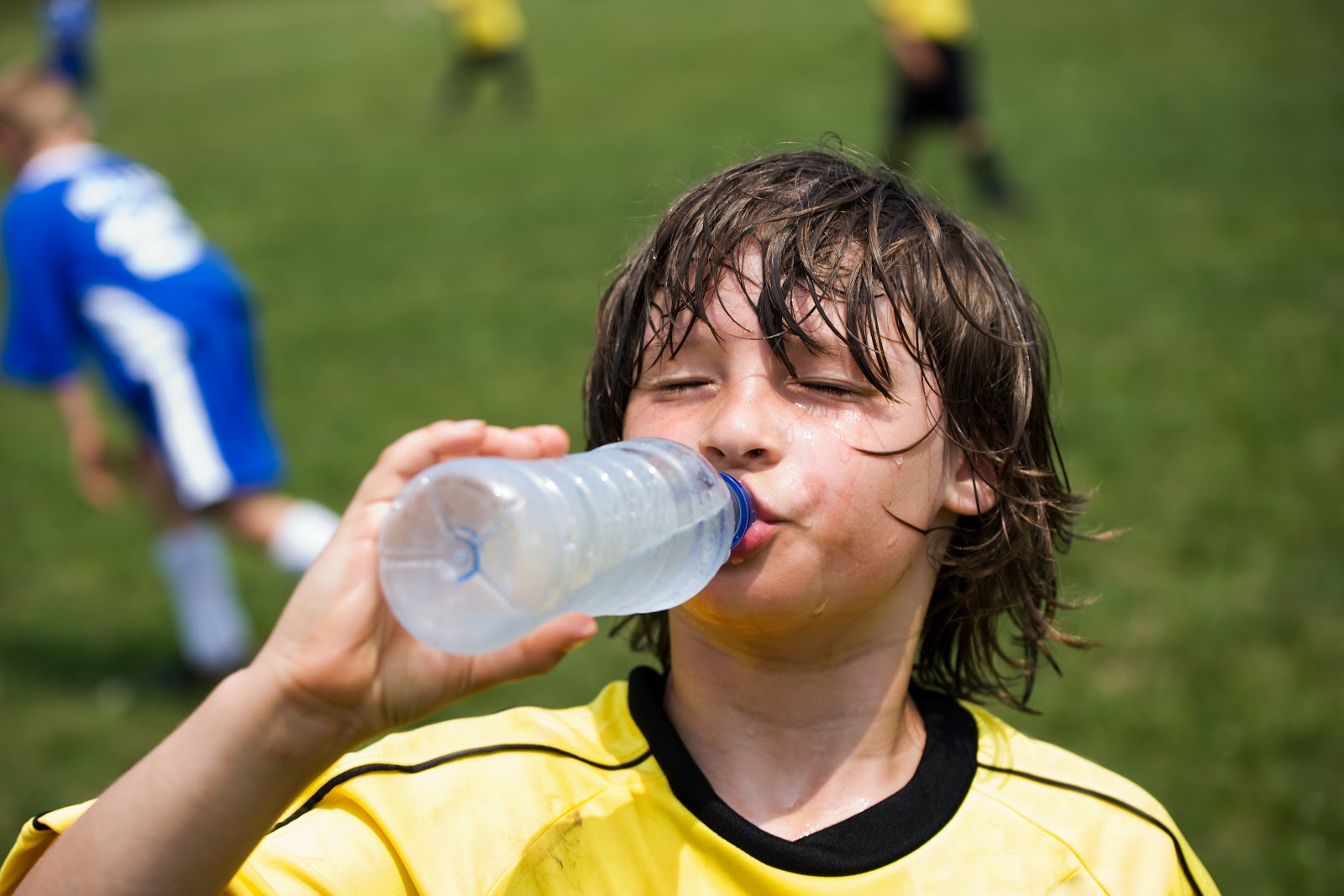 boy drinking water during a game