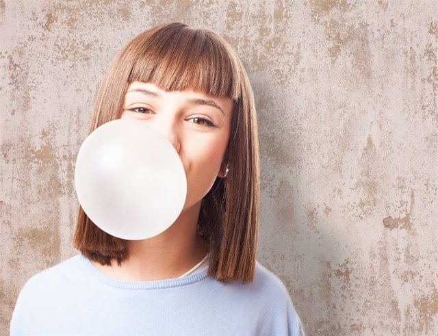 Girl blowing bubble with gum