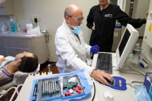 Dr. Scott Edward's in a dental appointment with a patient